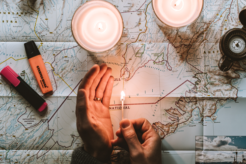 Hands holding a light over a map